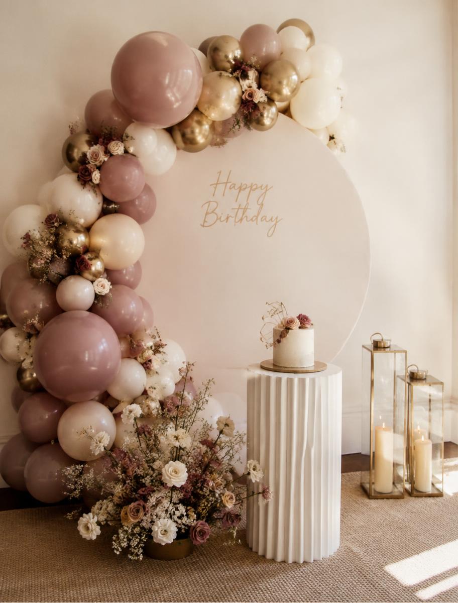 Mauve, cream and gold balloon backdrop with birthday cake